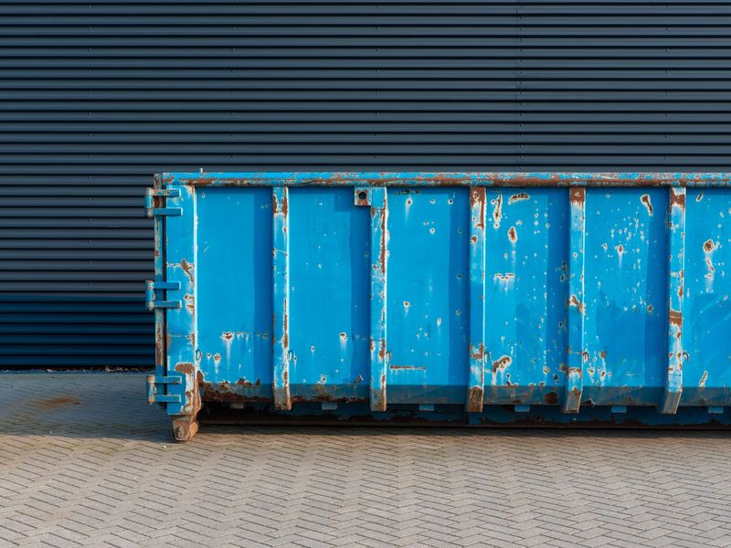 Blue roll-off dumpster for cleanout and debris dumpster rental in McGehee, AR