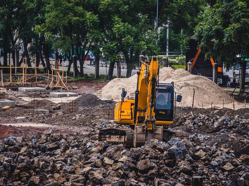 Yellow excavator working a job site, construction equipment rental in McGehee, Arkansas