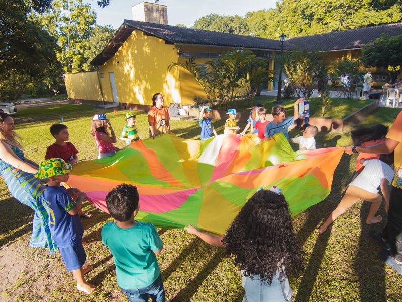 Children playing a parachute game at an outdoor event, party and event rentals in McGehee, AR